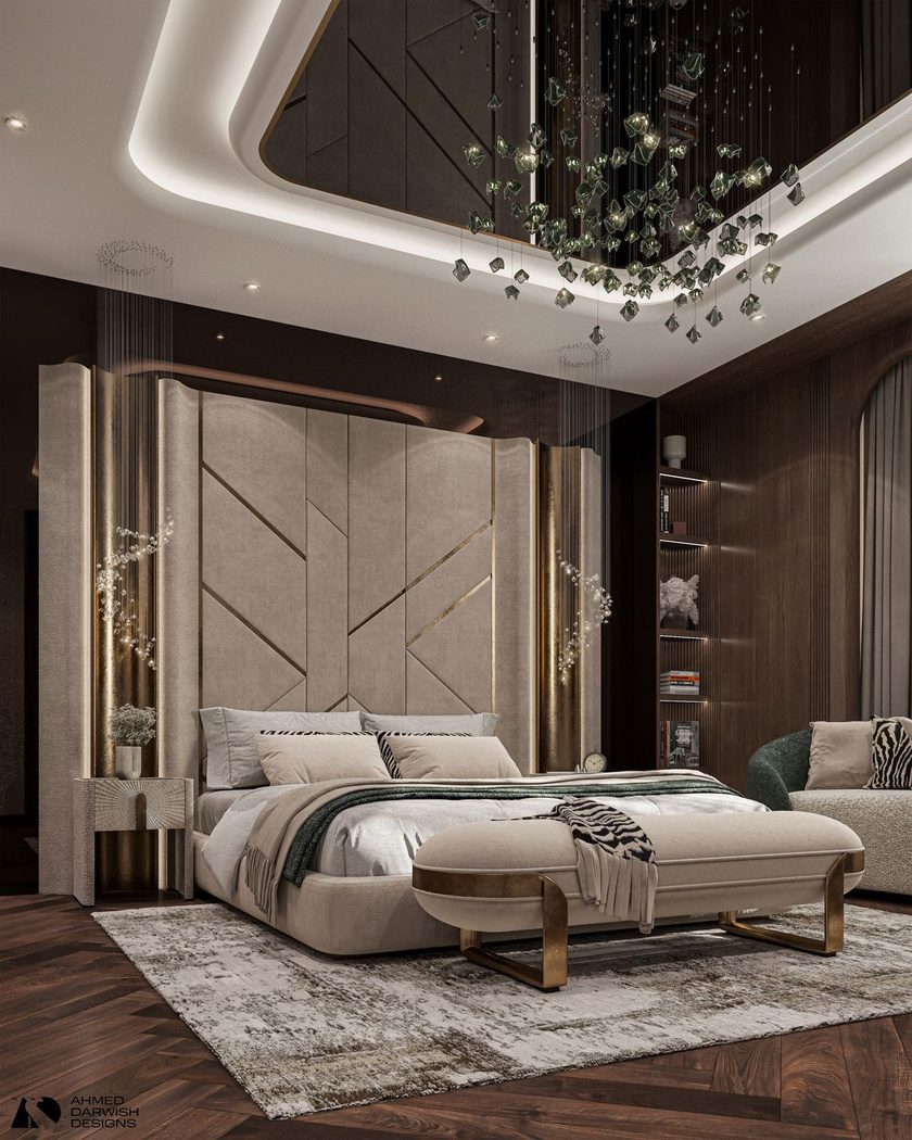 Bedroom with a panelled headboard wall and chandelier