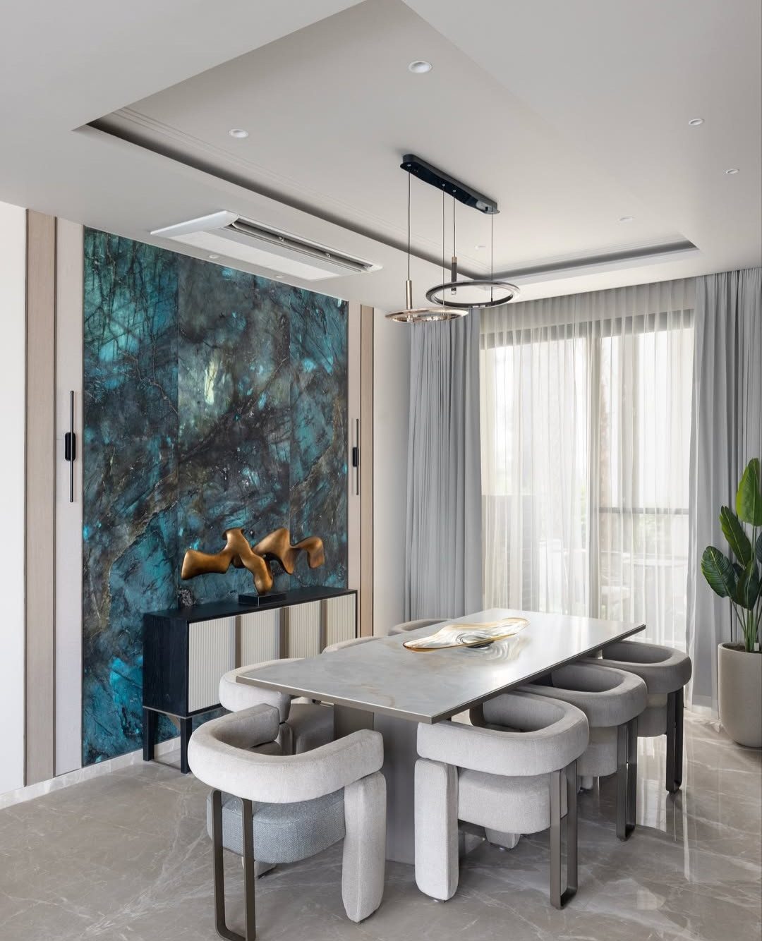 Dining area with a stone feature wall and pendant lighting