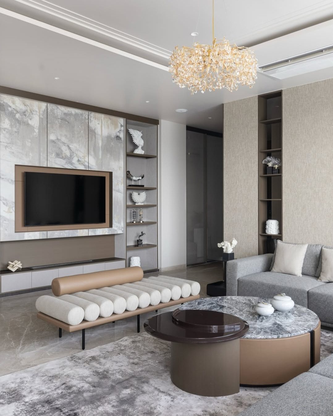 Living room with a marble media wall and display shelving